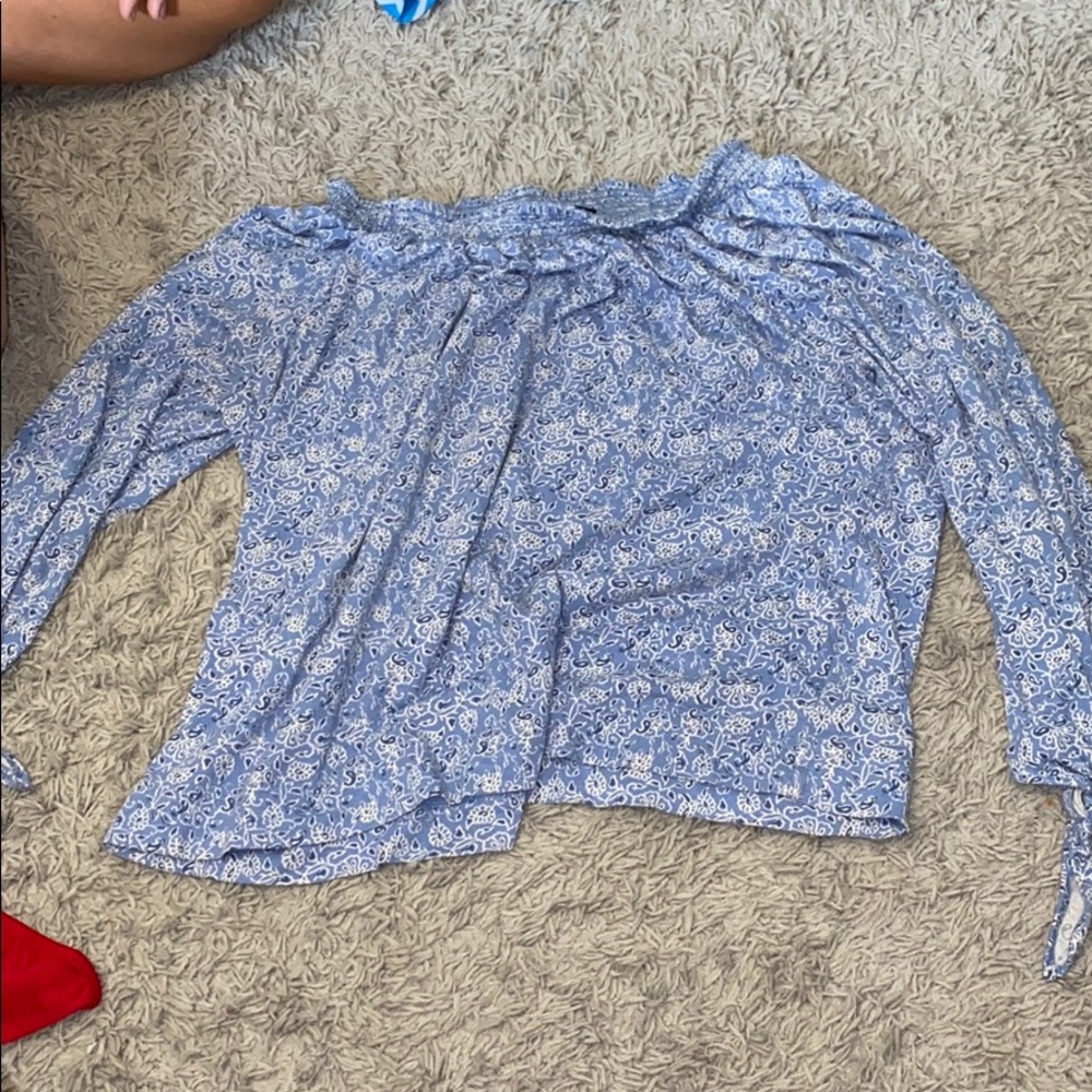 A blue off the shoulder long sleeve shirt